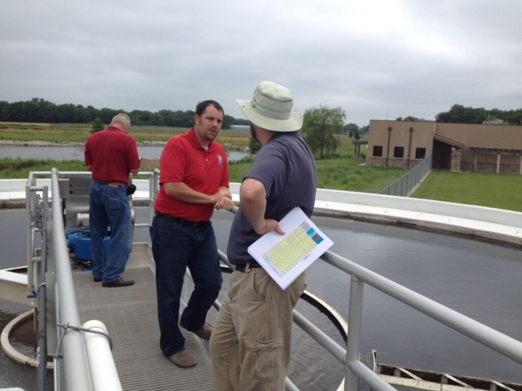 Image: EFC WSU Senior Program Manager Nicholas Willis (right) talks with water utility staff during an on-site technical assistance visit.